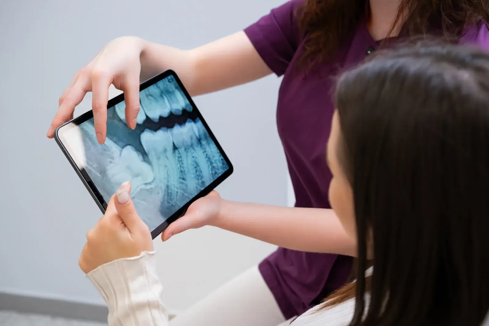 dentist-discussing-tooth-extraction-procedure-with-patient-showing-x-rays (1)